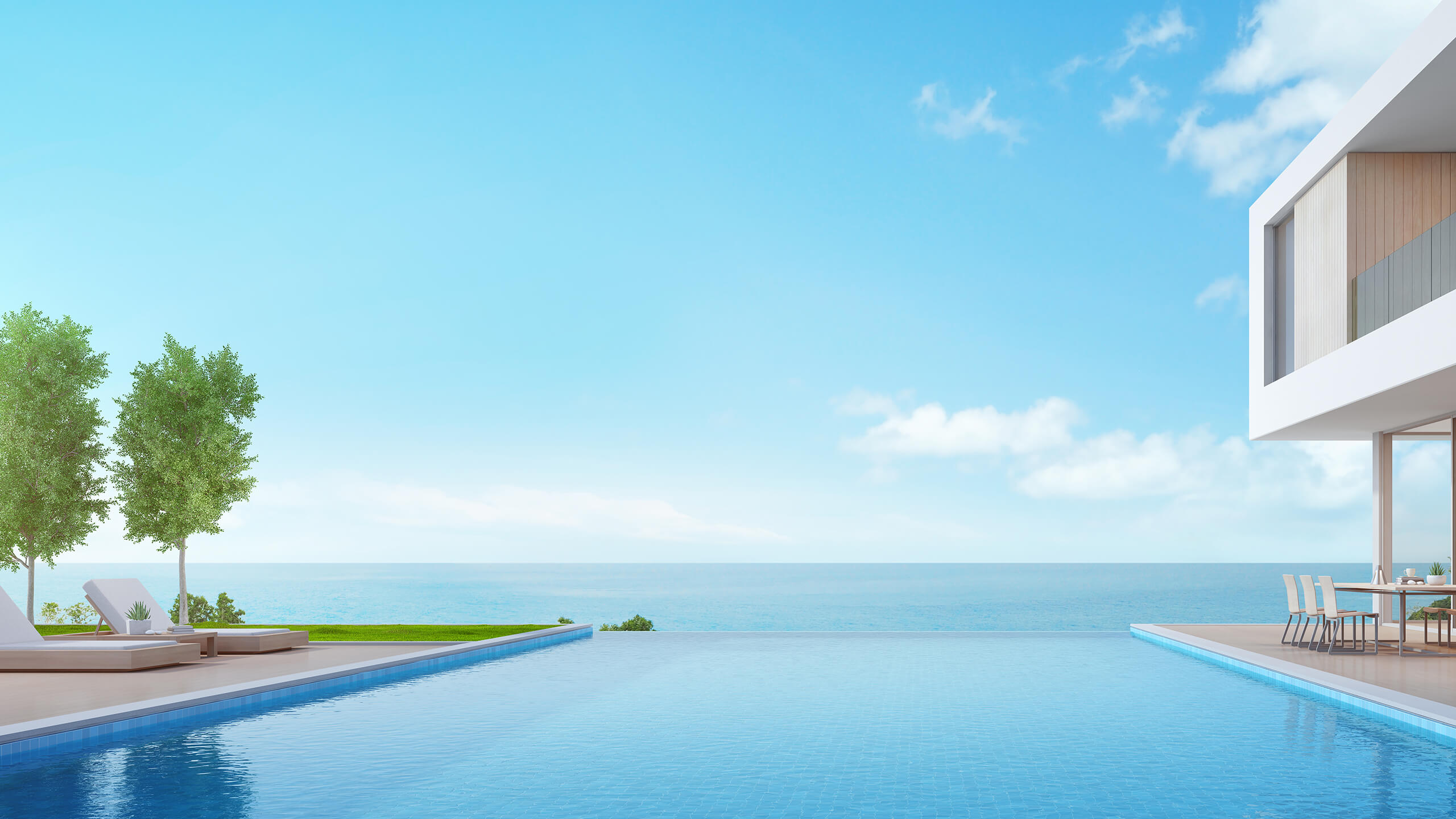 Coastal Capital Header Image. Infinity pool of a luxury modern house overlooking the blue ocean.